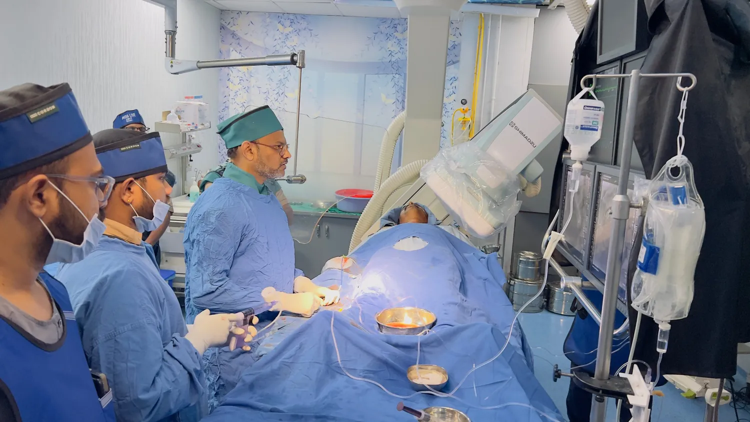 Cath lab team watching the X-ray screen during a heart procedure